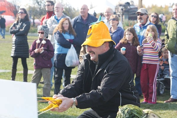 Okotoks Mayor Bill Robertson participates in the vegetable slingshot competition at Kayben Farms&#8217; Pumpkin and Scarecrow Festival, where Town of Okotoks council faced