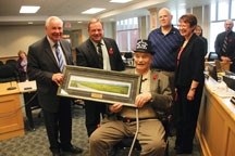 Former MD of Foothills secretary-treasurer Leonard Van Tighem is presented with a painting in celebration of his 100th birthday on Nov. 3 at the MD of Foothills office in