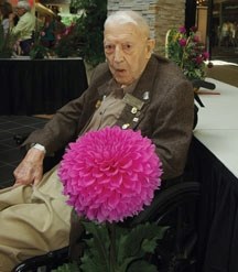 Ernie Henderson, 106, with his award-winning dahlia at the Alberta Dahlia and Gladiola show in August. Henderson passed away on Nov. 9. He was Canada&#8217;s oldest surviving 