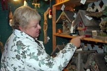 Marlene Gukert admires a birdhouse made by Priddis artist Jeri Kerluke at the Bragg Creek Christmas Craft Fair on Nov. 20.
