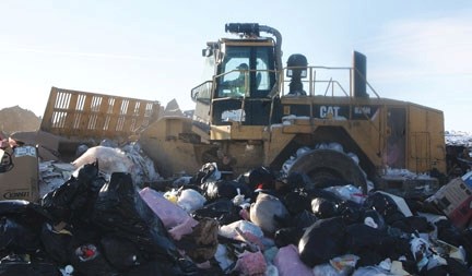 A Foothills Regional Landfill employee bulldozes garbage. The regional waste authority is contemplating its continued participation in the Southern Alberta Energy from Waste
