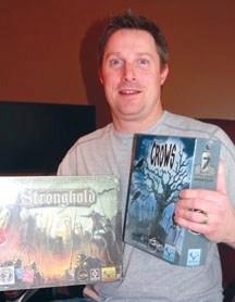 Valley Games vice-president Torben Sherwood shows off two of the games his company produced. Valley Games recently broke records on a creative project funding website.