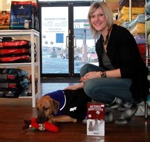 Kristal Read, owner of CHOW Bella Pet Health Food Store, with some of the possible Christmas gifts for her dog Leo.