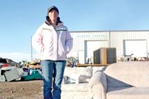 Candice Depass, assistant manager of the Foothills Salvage Society, outside the facility with furniture that had been soaked by rainfall the night before.