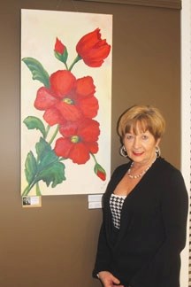 Okotoks artist Marg Smith shows off some of her artwork on display at the Sheep River Library until March 2, along with the work of Grace Langford.