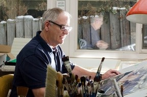 Brent Laycock sits at his desk in his home studio where he&#8217;s working on a watercolor painting on February 23 in Calgary, Alberta.