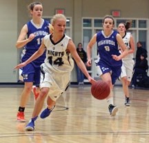 Holy Trinity Academy Knights&#8217; guard Charissa Hielema (14) runs in the open court as Highwood Mustangs Sara Stagg (11) and Molly Baldwin (8) try to keep up during the 3A 