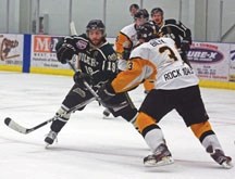 Okotoks Oilers&#8217; captain Derek Bacon has his route to the net blocked by Olds Grizzlys&#8217; defenceman Taylor Bilyk during Game 4 of the AJHL quarterfinal series March 