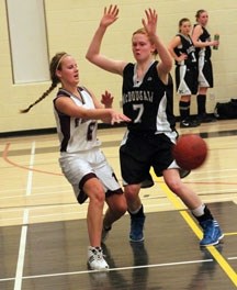 Foothills Falcon Noelle Reboul passes the ball around George McDougall Mustang Tori Zabel in the 4A South Central Zone final March 9 in Okotoks.