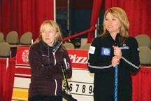 Amy Nixon (left) and Shannon Kleibrink share a moment while practicing at the Highwood Curling Club in 2011. After nine years as Kleibrink&#8217;s third, Nixon has left to