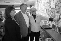 MD of Foothills councillor Barb Castell, left, Macleod MP Ted Menzies and Daine Osberg, Sheep River library chair, look at the tile wall at the library during the
