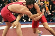 Reid Watkins, 17, right, here wrestling at the high school provincial championships in Okotoks, won his third consecutive national championship on April 13 in New Brunswick.