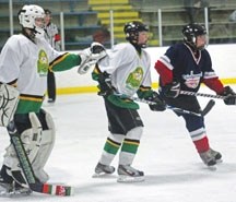 An Okotoks Oiler and Chestermere Laker battle for position in a Tier 1 hockey game in Okotoks. Hockey Calgary is proposing the ban of bodychecks at all Peewee levels.