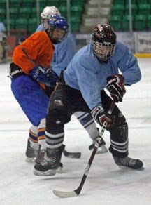 Okotoks resident Robbie McLean corrals the puck in traffic during the Okotoks Oilers spring camp, April 15 at Centennial Arena.