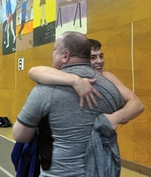 Reid Watkins hugs his father and coach, Doug Watkins, after winning the Juvenile Men&#8217;s 76kg final at the Canadian Wrestling Championships in Fredericton, New Brunswick
