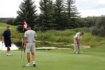 Gord Stauffer prepares to putt on the scenic sixth-hole green at Turner Valley Golf Club . All the courses in the foothills are expected to open this week.