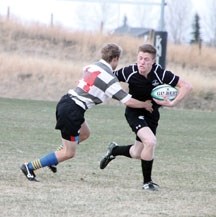 Holy Trinity Academy Knight Ken Ambrose tries to elude the tackle of a Springbank Phoenix player on April 19 in Okotoks. The Knights won the game handily.
