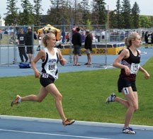 Holy Trinity Knight Emma Bibault, left, chases Jenna Westaway in the Senior girls 1,500m final at the Alberta high school track and field championships June 2 in Edmonton.