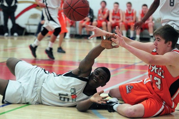 Okotoks Magic forward Austin xx fights for the ball with a Calgary Storm opponent during the CMBA spring league championship, June 9 at Lester B. Pearson School in Calgary.