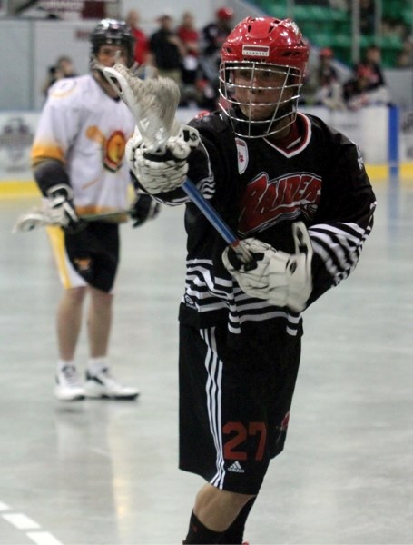 Okotoks Jr. Raider James Delaney snatches a loose ball during the Raiders&#8217; 14-6 win over the Edmonton Eclipse, June 9 at Okotoks Centennial Arena.