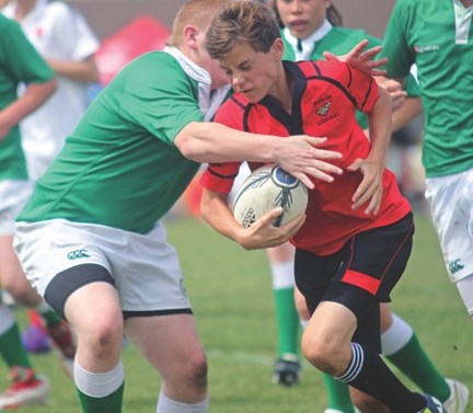 A Foothills U-15 Lion fights through traffic against the Calgary Canadian Irish Athletic Club during the Lions&#8217; Festival of Rugby, June 16 at the John Paul II