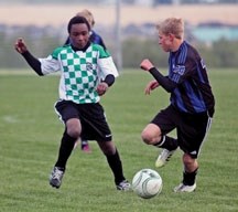 Okotoks U14 Strikers midfielder David Bowers, left, chases the ball in Calgary Minor Soccer Asssociation league action. The Strikers are in Edmonton this weekend for the