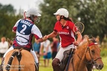 Team Canada&#8217;s Isabelle Ladiges, right, congratulates a Team French player after Team Canada&#8217;s 14-9 win in the final of the Equestre du Marquenterre in France July 