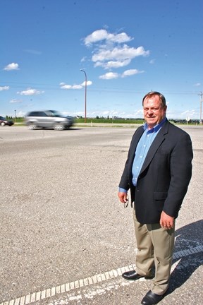 MD of Foothills Reeve Larry Spilak inspects the intersection of Dunbow Road and Highway 2, which will be studied by the Province to determine if it is safe.