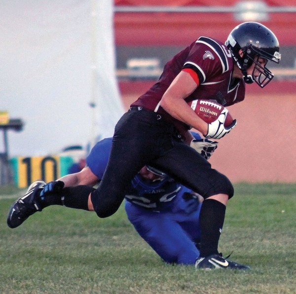 Foothills Falcons wide receiver Garrett Young runs through an attempted tackle during the Falcons&#8217; 42-21 win over the Harry Ainlay Titans, Sept. 7 at Falcons field in