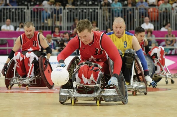Zak Madell of Okotoks (front) pushes the ball up the court during Team Canada&#8217;s match agaisnt TEam Sweden in wheelchair rugby at the London 2012 Paralympic Games in the 