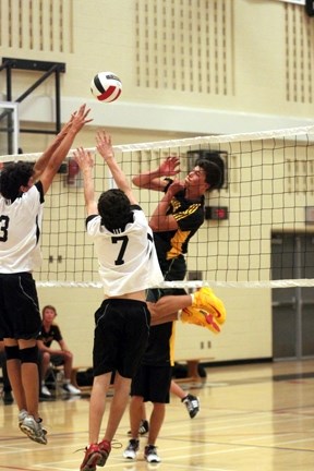 Oilfields Driller Brandon Powell powers the ball over two Holy Trinity Knights on Sept. 19. The Drillers are playing in the Foothills Athletic Council Senior boys volleyball