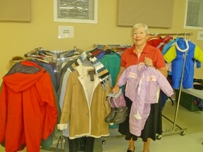 Jacket Racket coordinator Ida Wegelin holds up items available at the Lewis Memorial United Church.
