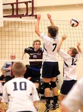 Foothills Falcon Shaeden Howse (9) watches his spike go past a pair of Strathcona-Tweedsmuir Spartans on Nov. 14. The Falcons downed the Spartans in three straight games in