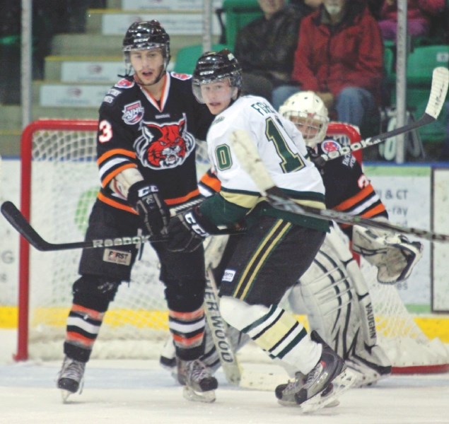 Okotoks Oiler Robbie Fisher battles for net presence with the Lloydminster Bobcats last month. The Oilers defeated the Bobcats 4-3 in overtime on Saturday, the first of two