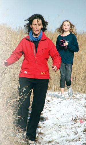A pair of runners head down a trail at the Okotoks cross-country run in 2011 at Strathcona-Tweedsmuir School. The 23rd annual run takes place Saturday at noon at the school