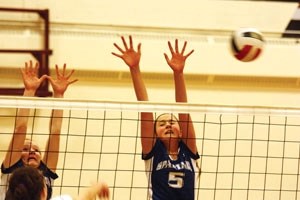 Strathcona-Tweedsmuir Spartans Kenzie Walker and Ciara Hanly go up for a block in the Foothills Falcon tournament earlier this season. The Spartans finished fourth in the 2A