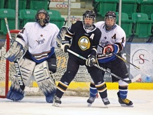 Okotoks Midget AA Oiler Harrison Smith battles for position near the blue paint with Cranbrook Ice Randy Teeple. The Oilers won the SCAHL game 4-1, Saturday at the Pason