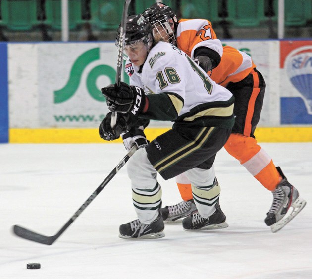 Okotoks Oiler Mitch Collett escapes the check of Drumheller Dragon Christopher Rauckman on Saturday at the Pason Centennial Arena. The Dragons cruised to a 6-2 win.