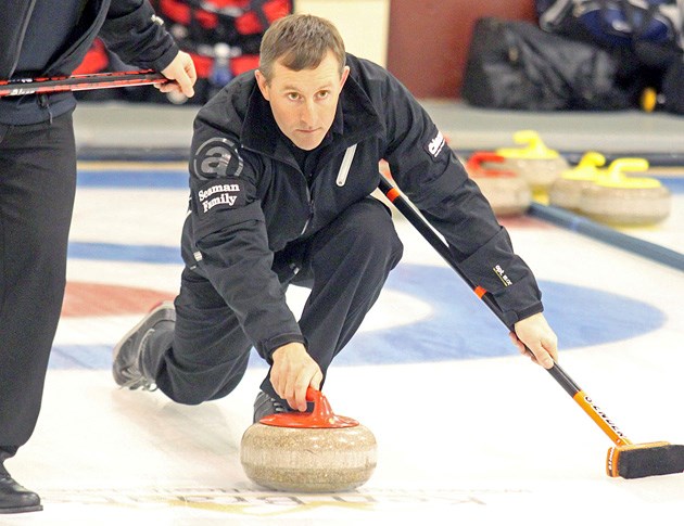 Peter Keenan, the lead for the Mike Libbus rink out of Black Diamond, comes out of the hack during the C-event of the Southern Alberta Curling Association districts on Sunday 