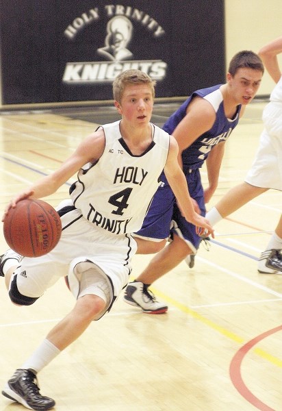 Holy Trinity Academy Knight Dylan Wheeler drives to the basket against the Highwood Mustangs on Dec 12. Wheeler is the first Grade 10 student to start the season at point