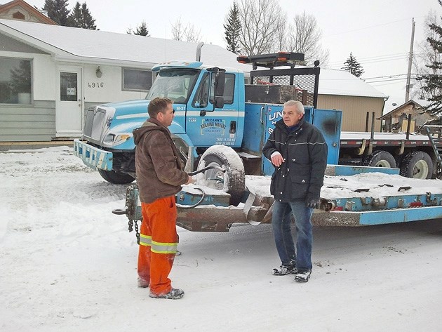 Turner Valley resident Willi Craciun chats with McCann&#8217;s Building Movers part owner Pat McCann on Monday morning in front of his new house. The home was donated to