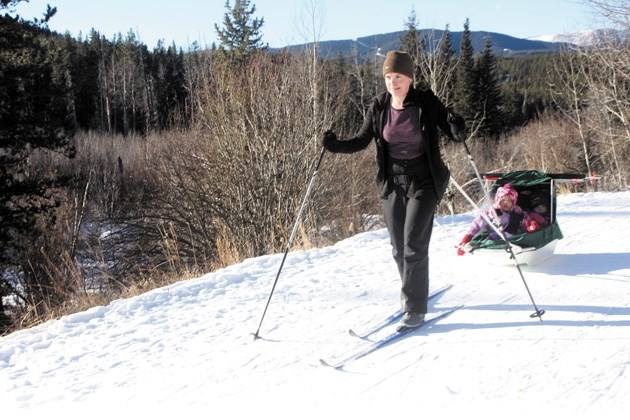 Becky Cryne hauls two of her children along the Mountain Road at West Bragg Creek on Jan. 5. West Bragg Creek provides 45 kilometres of trials as well as a designated