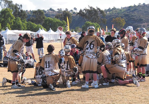 Okotoks Mustangs field lacrosse coordinator Jesse Fehr, middle, relays instructions to his players at the Adrenaline Team Elite/High School Challenge in San Diego County.