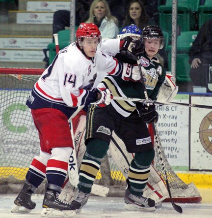 Okotoks Oilers co-captain Robbie Fisher battles for net front real estate with Brooks Bandit Nick Newman during the Oilers&#8217; 3-2 win, Tuesday night at Pason Centennial