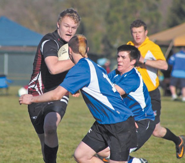 Foothills Lion Jamie Irving bursts through a hole during the Sacramento Kick-Off Rugby Tournament in late January. Irving was one of 16 Foothills Lions players to compete