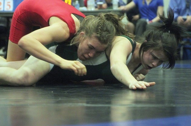 Foothills Falcon Cassidy Barnert, in red, breaks down Carlie Gendre in the 61kg gold medal match at the high school wrestling rural provincial championships Feb. 23 in High