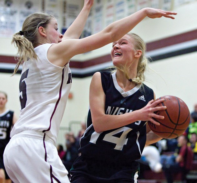 Jenna Thomson of the Foothills Falcons tries to block Charissa Hielema of the HTA Knights from driving to the basket during the Senior girls Foothills Athletic Council final