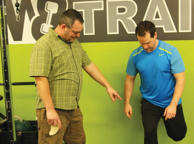 Rick Merriam coaches W8 Trainer owner and operator Andrew Dexter through proper exercise during a bio-mechanics seminar on the virtues of Muscle Activation Technique.