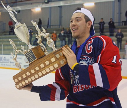Okotoks Bisons captain Chase Fallis hoists the Russ Barnes Trophy after the Okotoks Bisons won the Junior B provincial gold medal in an 8-4 win over Sherwood Park, at the