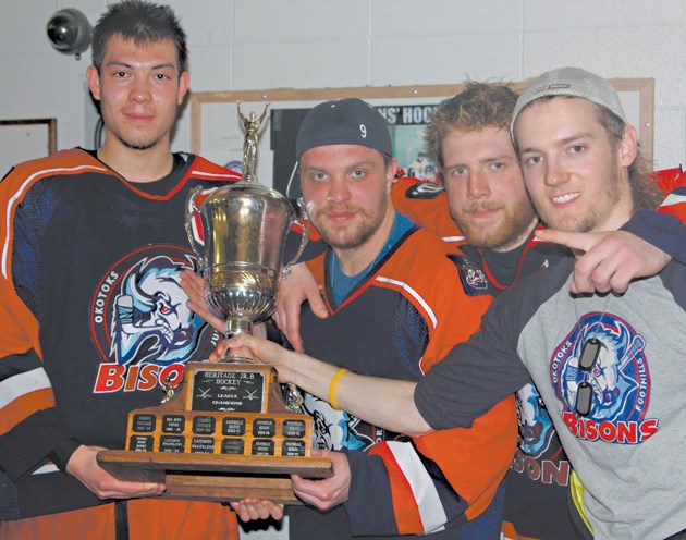 Okotoks Bisons graduating players Chase Fallis, Jeremy Smith, Zach Baba and Ty Fehr pose with the Heritage Junior Hockey League trophy. The four players helped Okotoks to its 
